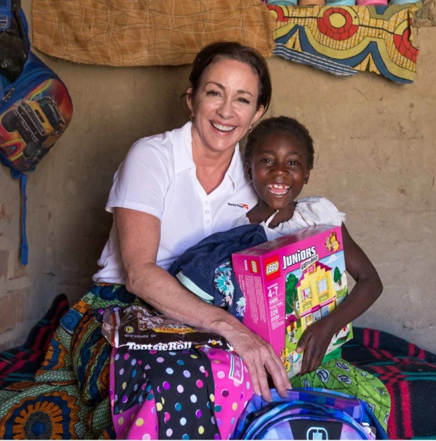 Actress Patricia Heaton meets her World Vision sponsored child 8-year-old Gracious, in Hamaundu, Zambia. Sponsor a child, sponsoring a child, child sponsor, celebrity ambassador