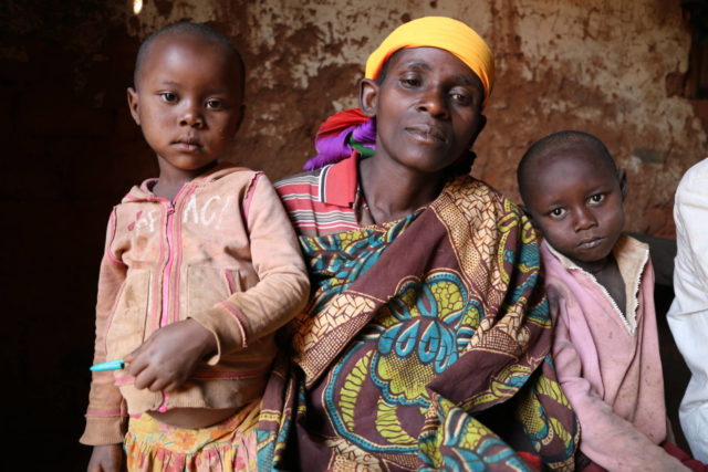 Julia mourns her son, Ndayizeye, who recently died from malaria. Young Ines and Elvis (left and right) are the boy’s cousins. (©2016 World Vision, Achel Bayisenge)