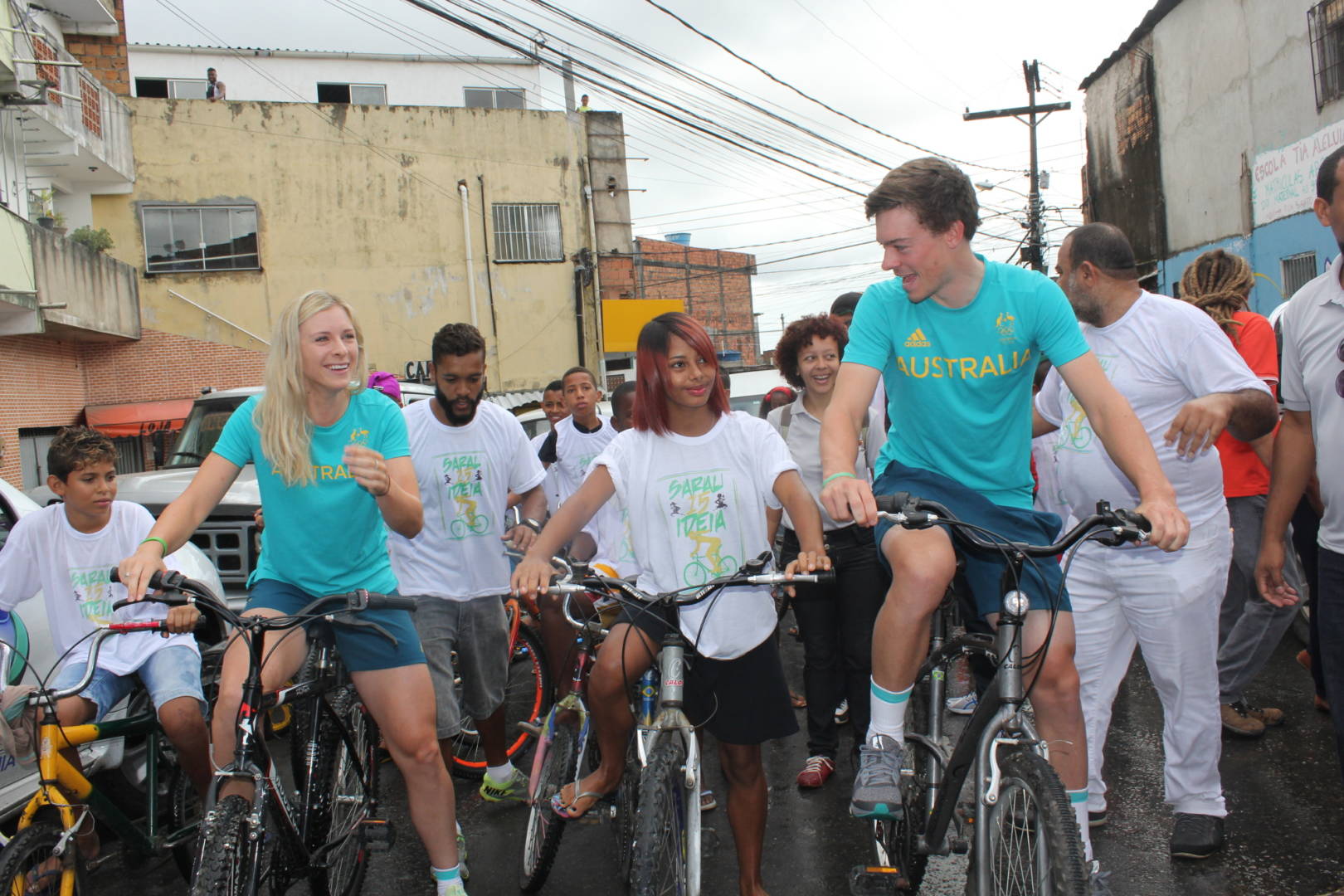 Olympian cyclists Annette and Alex Edmondson ride bikes with World Vision sponsored child Vanessa and her youth group in Brazil.