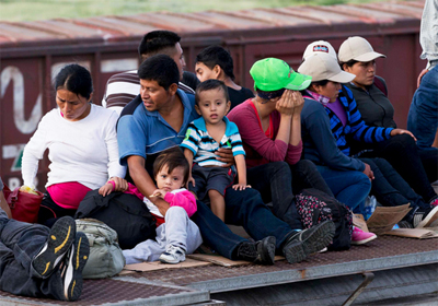 Central American migrants ride a freight train during their journey toward the U.S.-Mexico border in Ixtepec, Mexico on July 12, 2014. Eduardo Verdugo—AP