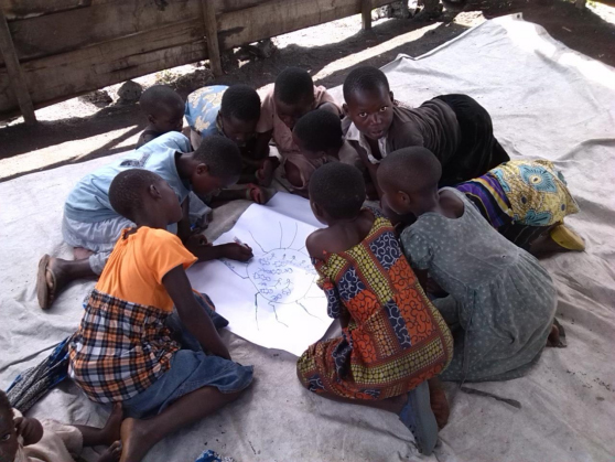 Girls in Bulengo Camp (Goma, DRC) drawing a "spider diagram." PHOTO: World Vision