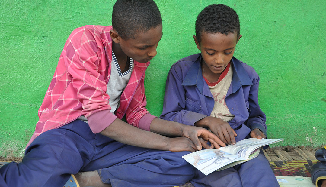 Giduma taught his siblings to read. How? Reading Buddies, a World Vision program that trains children how to read with and teach other kids how to read.