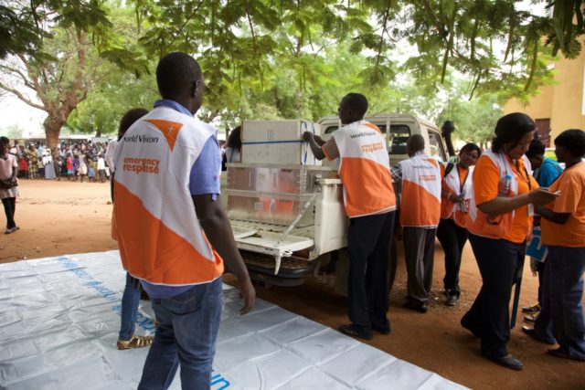 World Vision staff help hand out supplies to people displaced by the latest wave of violence in South Sudan. PHOTO: World Vision/Jeremiah Young