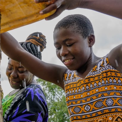 girl getting clean water from well