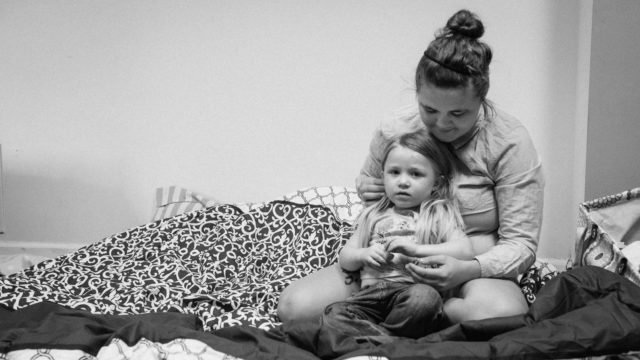 Little girl from Georgia who had to evacuate because of Hurricane Matthew. She sits on the floor with her older sister.